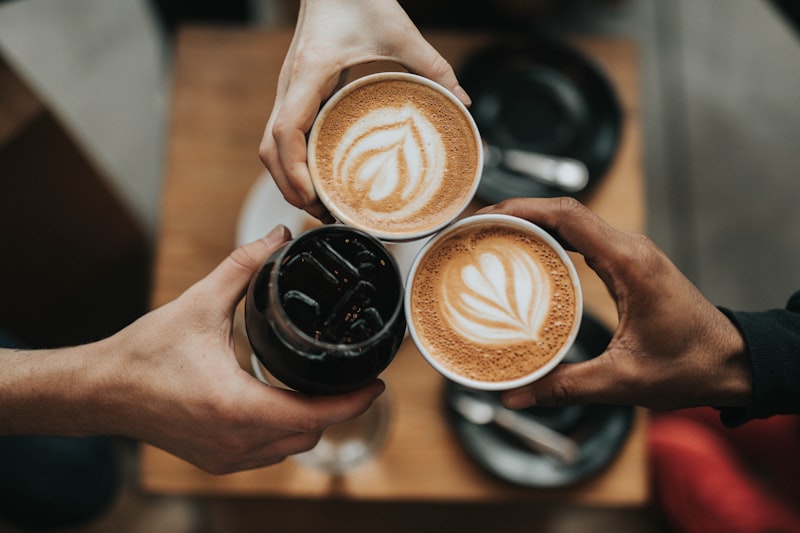 A handwritten journal beside a cup of coffee on a cafe table